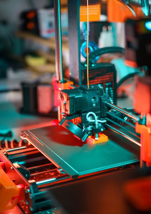 3D printer creating a prototype component in a workshop